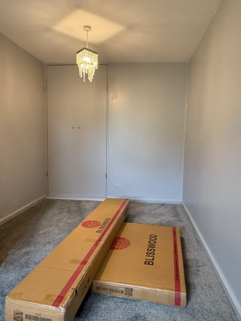 Empty room with flat pack cardboard boxes waiting to be assembled